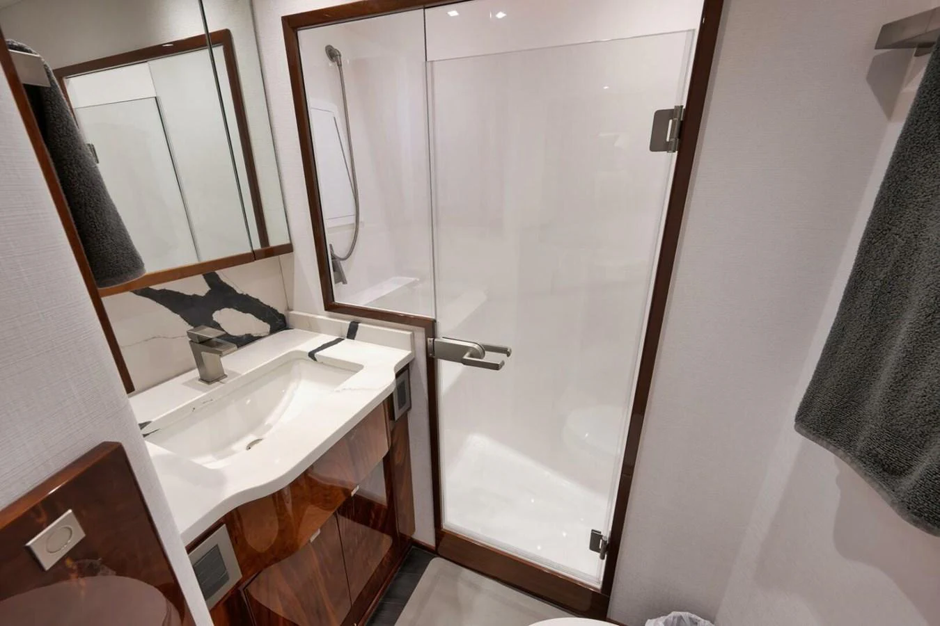 The yacht's bathroom features a sleek design with a glass-enclosed shower and modern fixtures. aboard NIKKI BELLA Yacht for Sale