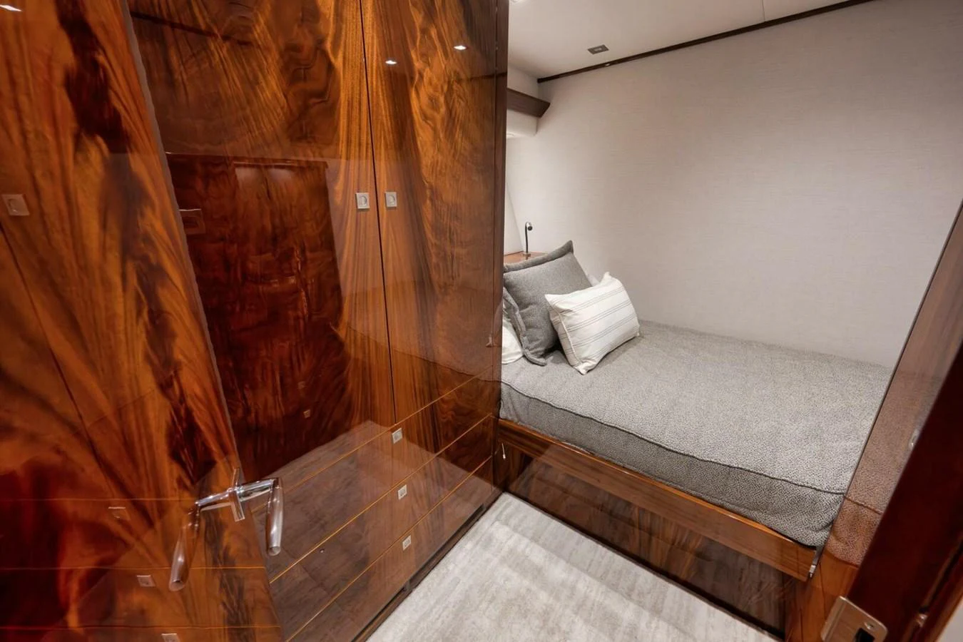 A cozy stateroom with a luxurious wooden finish and a comfortable bed. aboard NIKKI BELLA Yacht for Sale