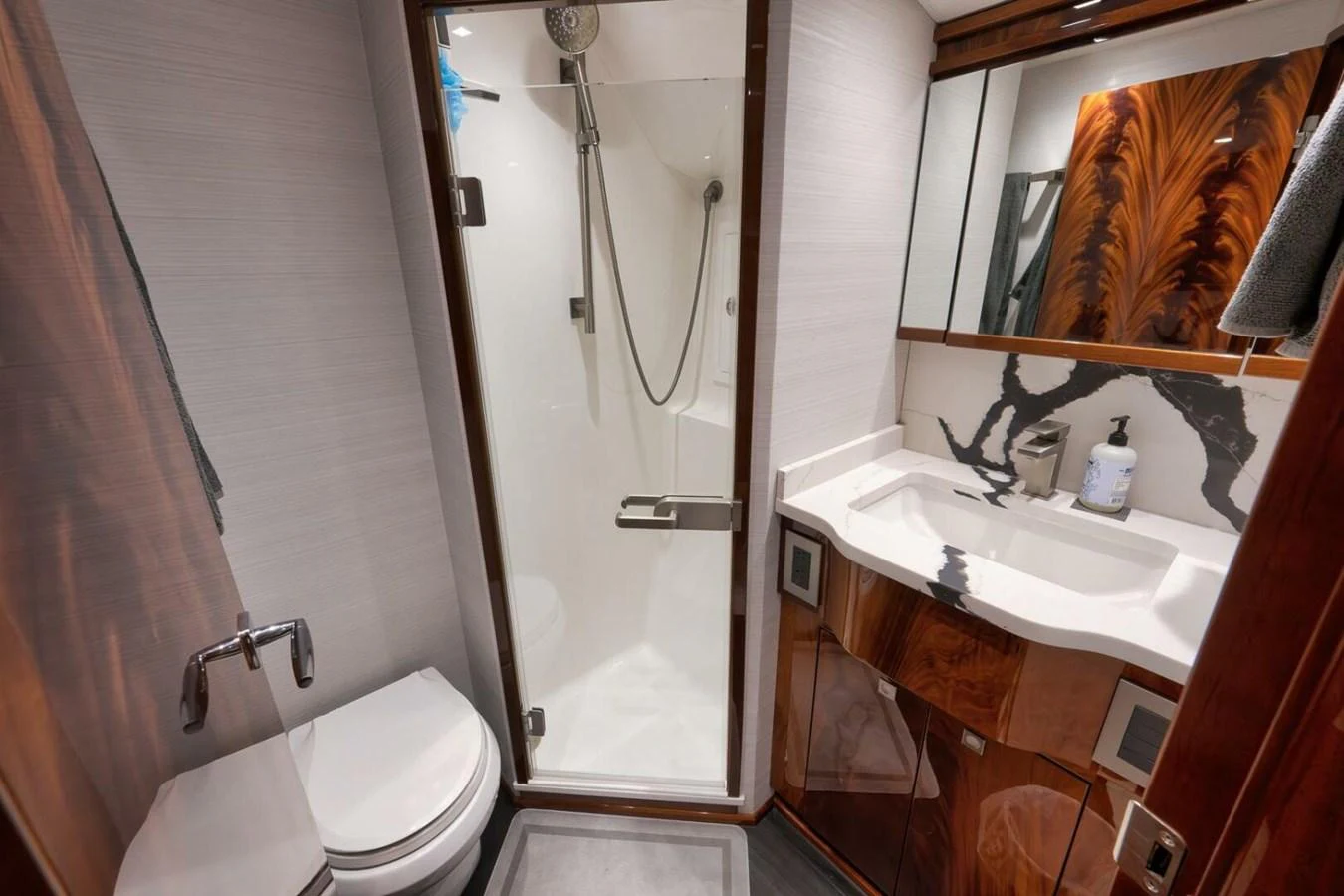 A luxurious yacht bathroom featuring a modern shower and elegant wood accents. aboard NIKKI BELLA Yacht for Sale