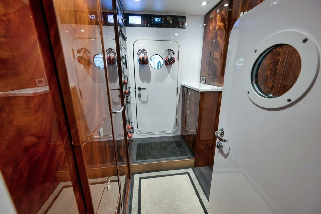 A well-appointed interior space featuring a door with a porthole window and polished wood finishes. aboard NIKKI BELLA Yacht for Sale