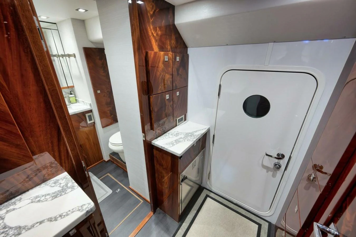 The yacht's head features elegant wood paneling and a sleek, modern design. aboard NIKKI BELLA Yacht for Sale