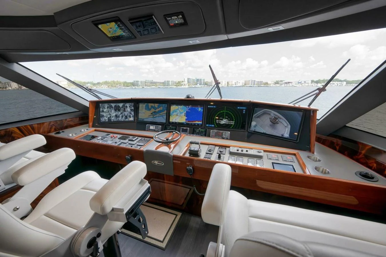 The helm station features advanced navigation equipment and luxurious seating with a panoramic view. aboard NIKKI BELLA Yacht for Sale
