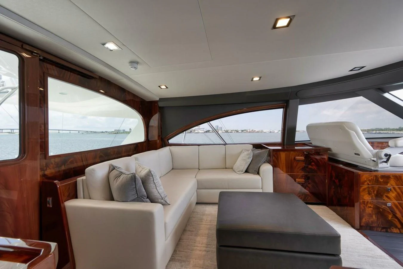 The yacht's salon features a luxurious seating area with large windows offering panoramic views. aboard NIKKI BELLA Yacht for Sale