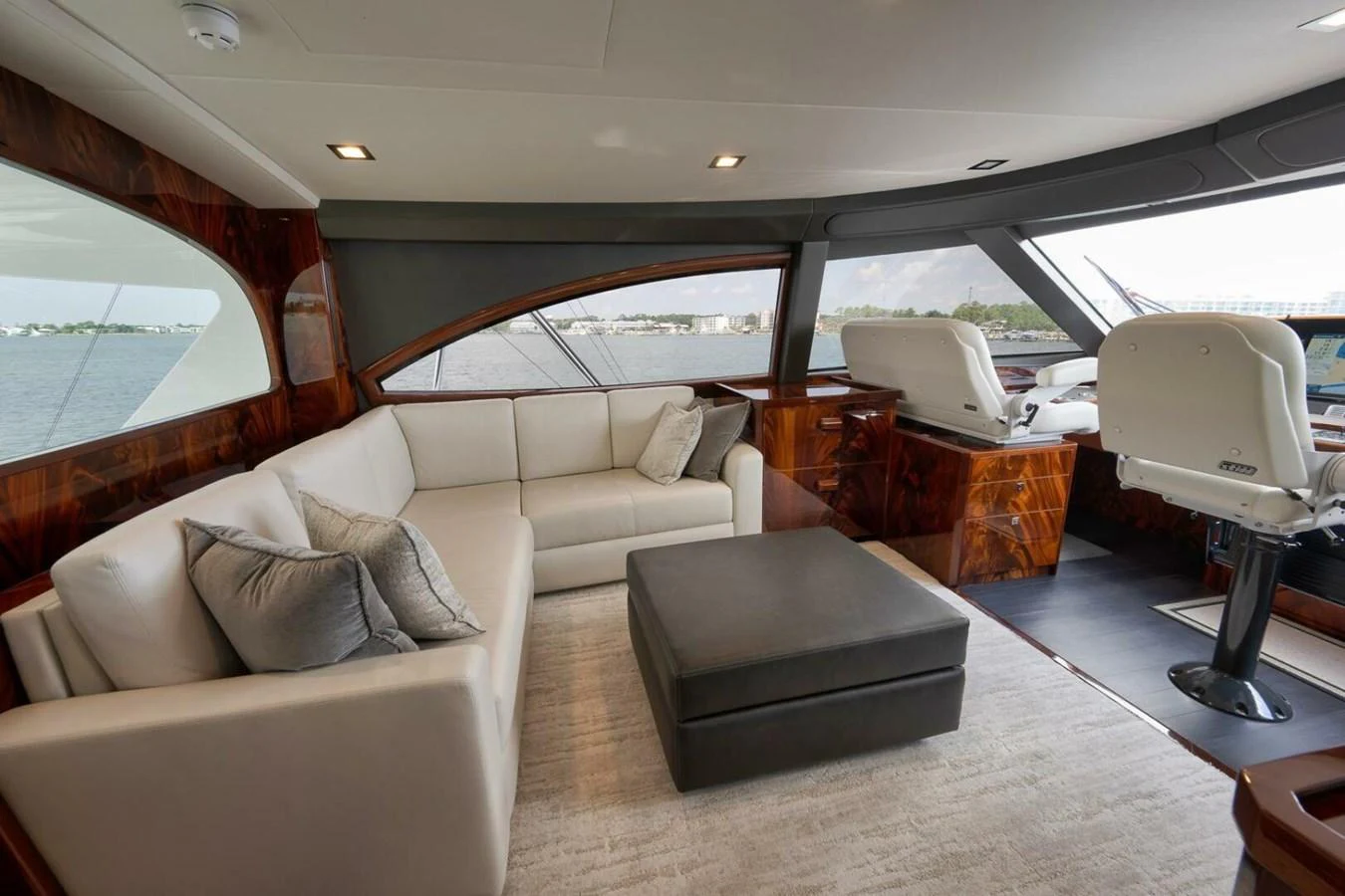 The salon features a comfortable seating area with a large window offering scenic views. aboard NIKKI BELLA Yacht for Sale