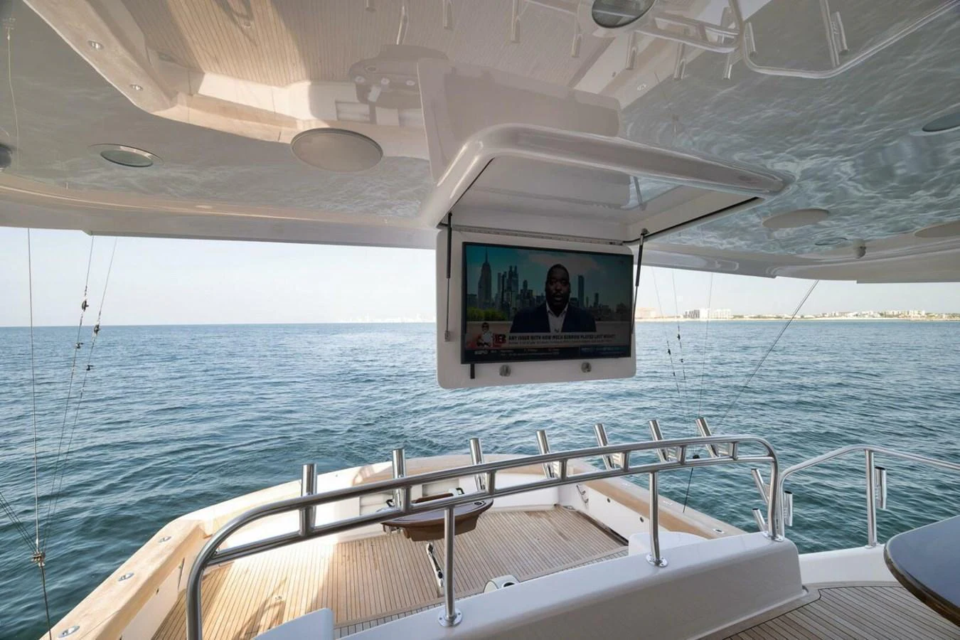 The aft deck features a mounted television for entertainment while enjoying the sea view. aboard NIKKI BELLA Yacht for Sale