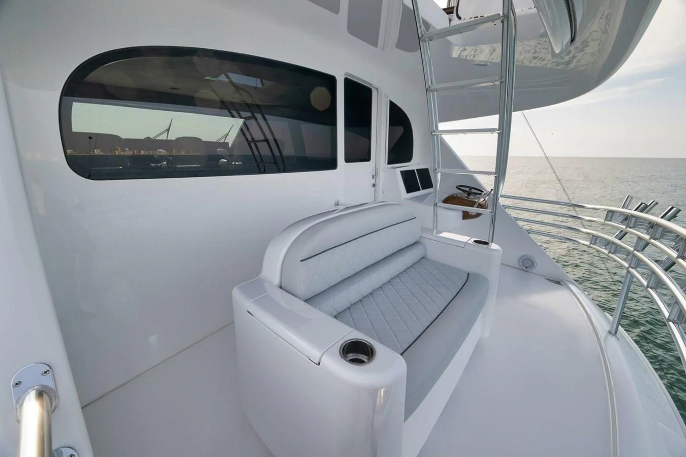 The flybridge offers a comfortable seating area with panoramic ocean views. aboard NIKKI BELLA Yacht for Sale
