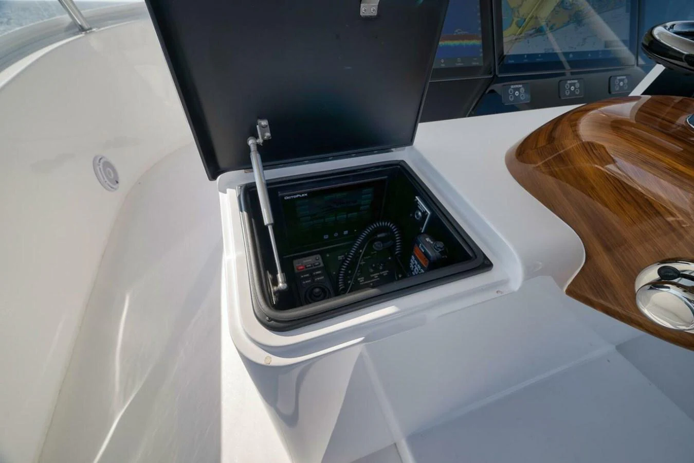A close-up view of the helm station with a hidden compartment for navigation equipment. aboard NIKKI BELLA Yacht for Sale