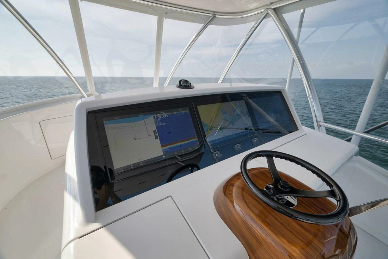 The helm station offers a commanding view with advanced navigation systems and a sleek steering wheel. aboard NIKKI BELLA Yacht for Sale