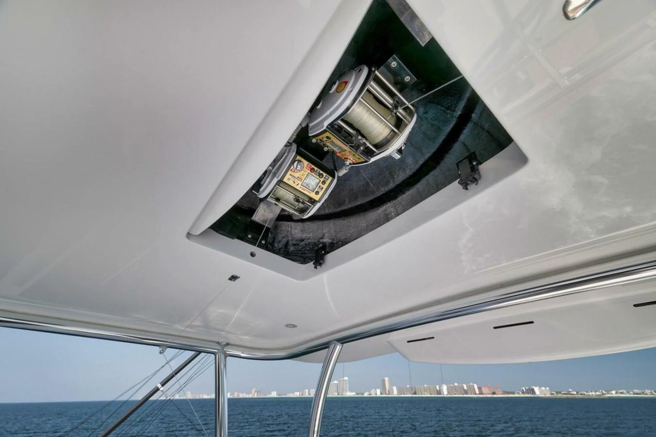 A close-up view of the yacht's ceiling-mounted equipment with a scenic ocean backdrop. aboard NIKKI BELLA Yacht for Sale
