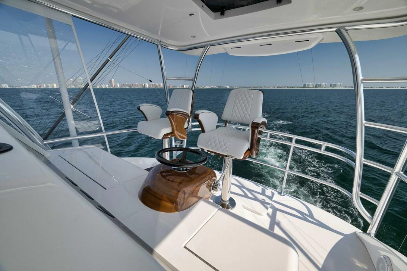 The helm station offers a commanding view of the open sea with luxurious seating and advanced controls. aboard NIKKI BELLA Yacht for Sale