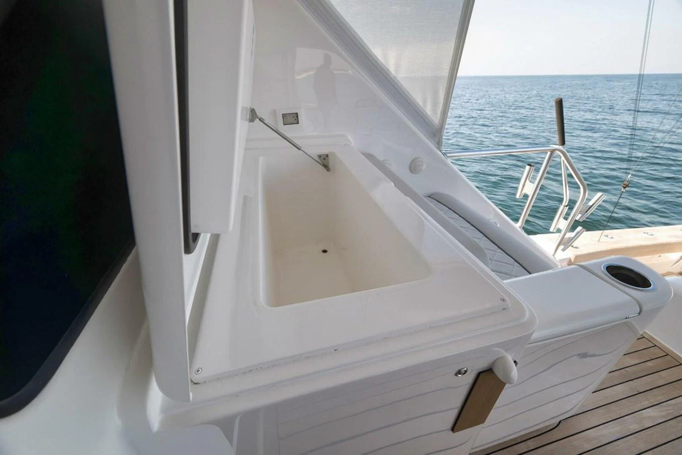 The image showcases a clean, white storage compartment on the yacht's deck, with the sea visible in the background. aboard NIKKI BELLA Yacht for Sale
