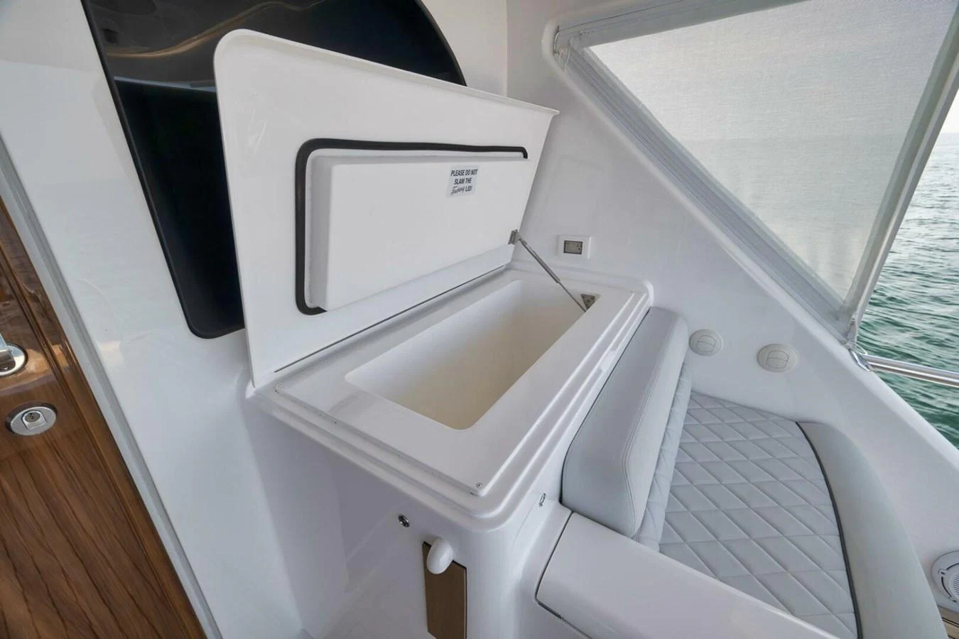 A sleek storage compartment with a cushioned seating area on a yacht. aboard NIKKI BELLA Yacht for Sale