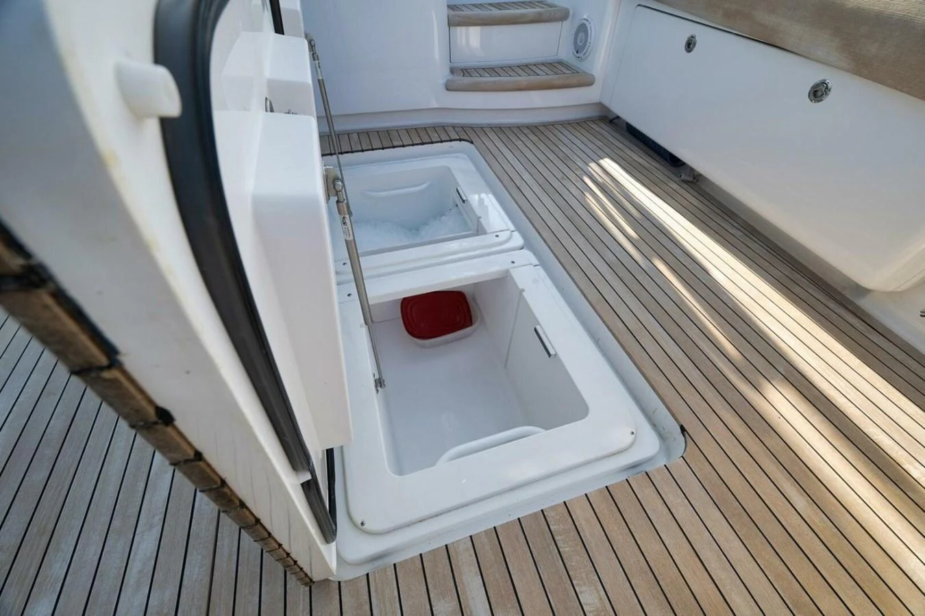 The image shows a storage compartment with an open lid on the deck of a yacht. aboard NIKKI BELLA Yacht for Sale