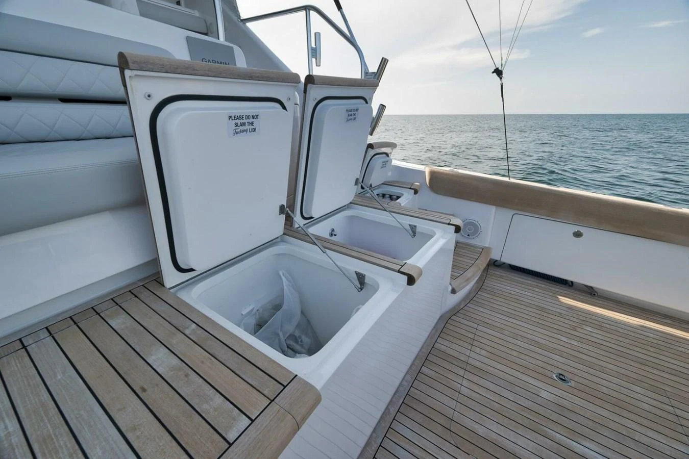 The aft deck features open storage compartments with a view of the sea. aboard NIKKI BELLA Yacht for Sale