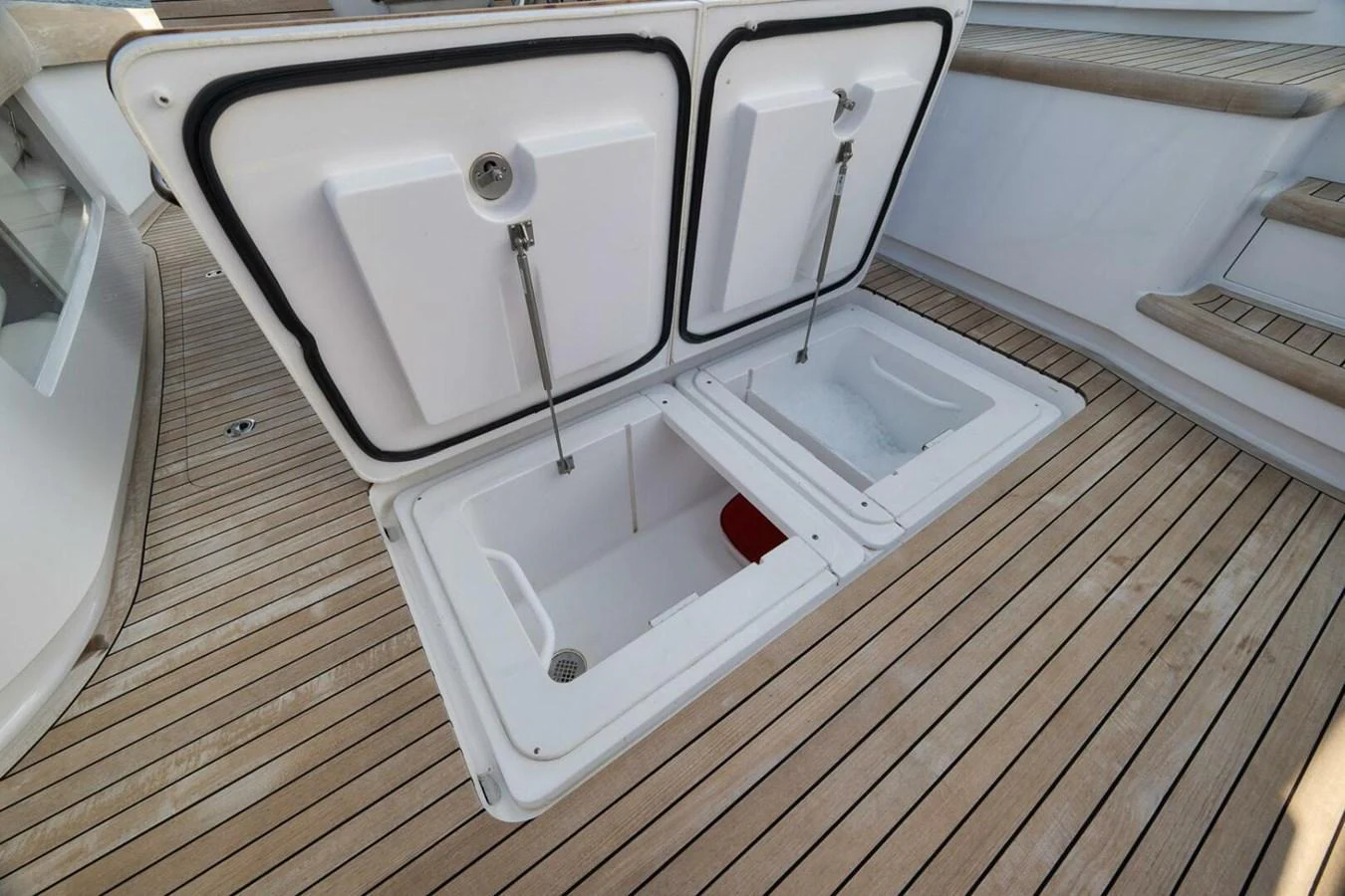 The image shows an open storage compartment on the yacht's deck, revealing ample space for equipment or provisions. aboard NIKKI BELLA Yacht for Sale
