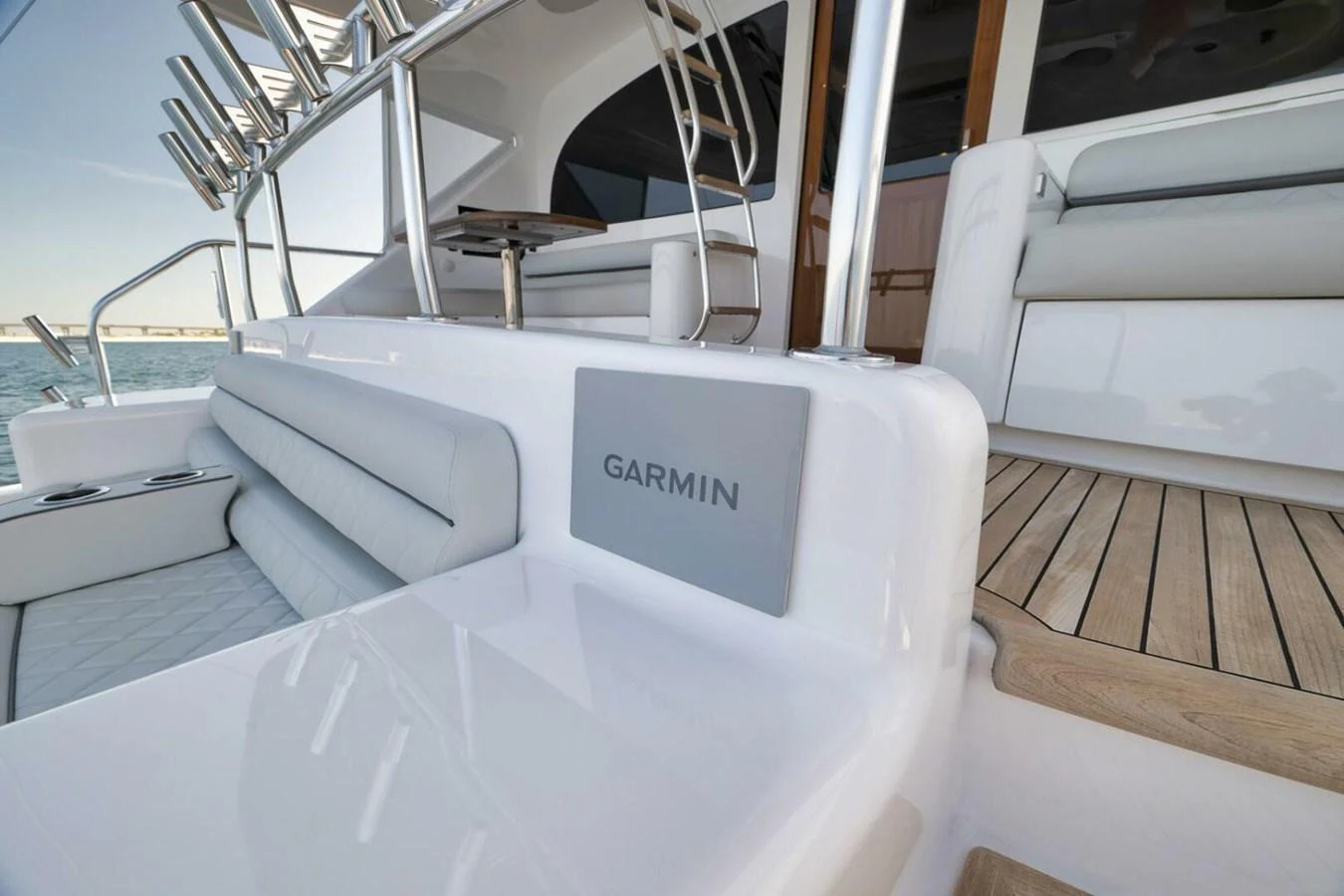 A close-up view of a yacht's seating area and deck with a Garmin device. aboard NIKKI BELLA Yacht for Sale