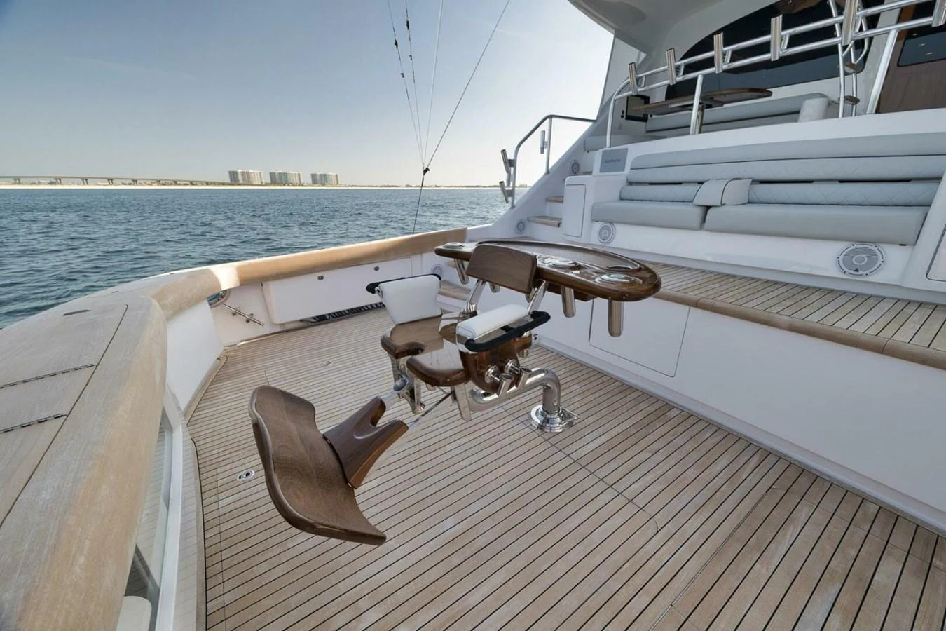 The aft deck features a fishing chair and ample seating, perfect for relaxation and sport. aboard NIKKI BELLA Yacht for Sale