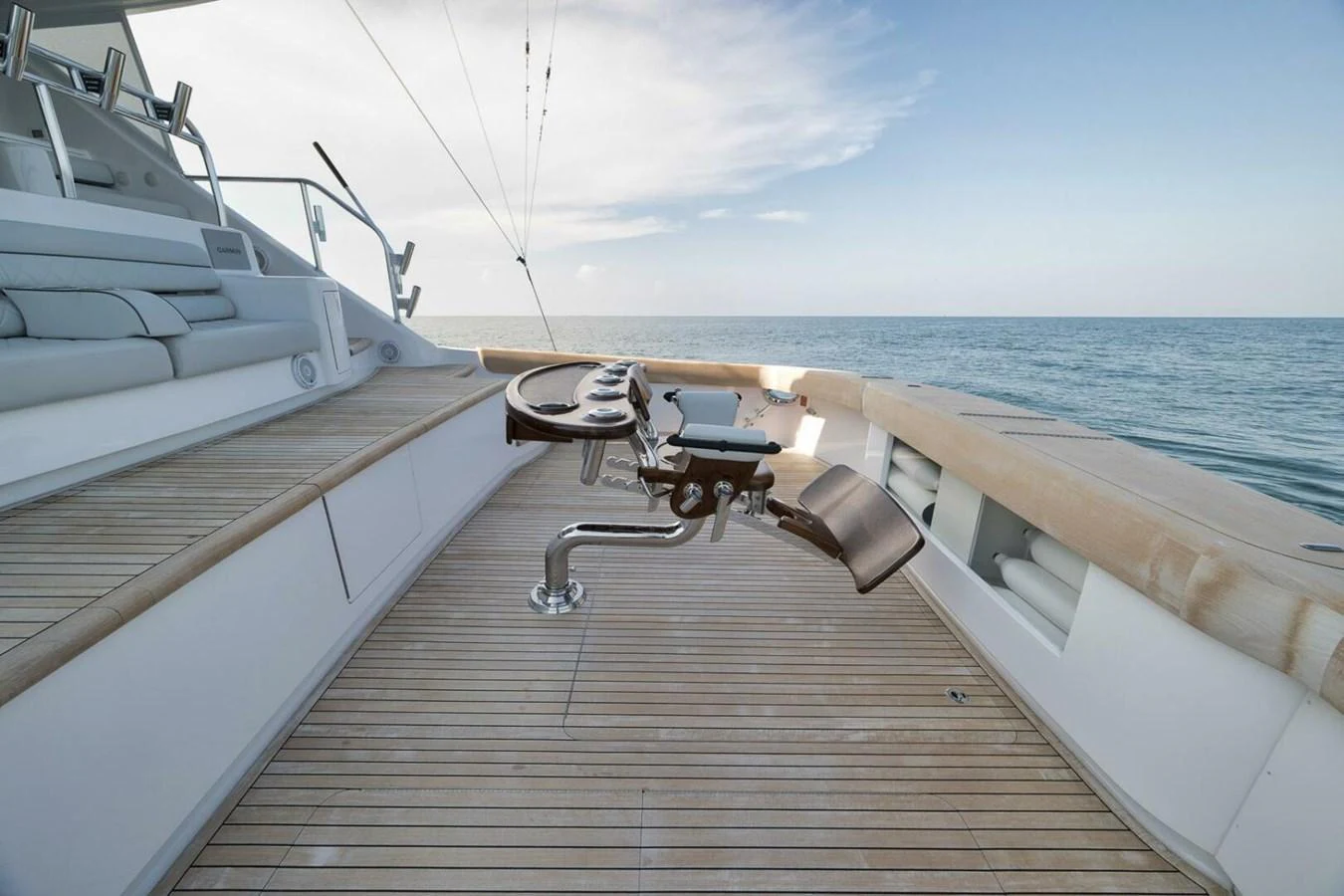 The aft deck features a luxurious fishing setup with comfortable seating and a panoramic ocean view. aboard NIKKI BELLA Yacht for Sale