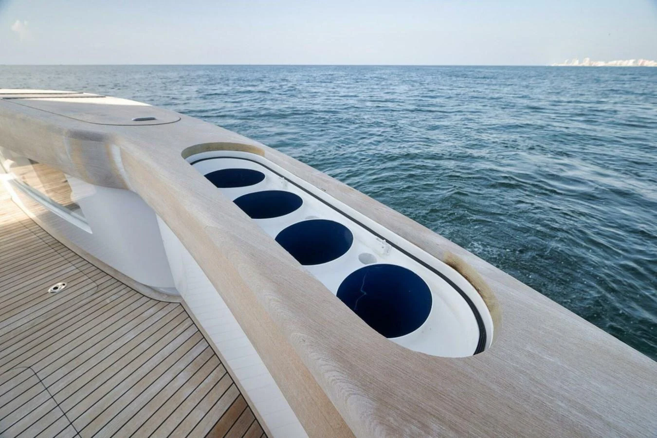 A sleek yacht detail showcasing a modern, streamlined design with integrated cup holders on the deck. aboard NIKKI BELLA Yacht for Sale