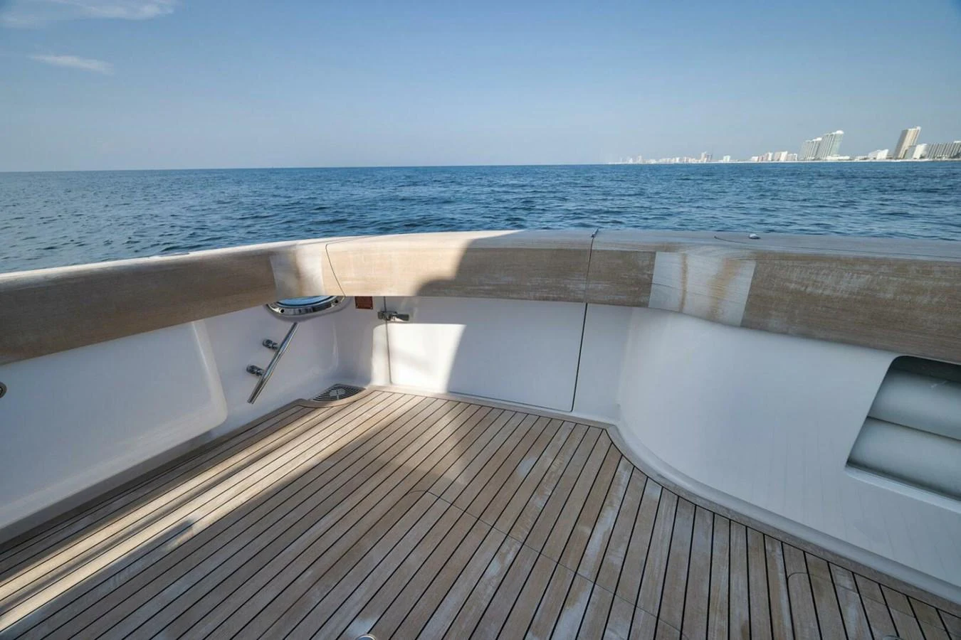 The aft deck offers a spacious area with a beautiful view of the ocean and distant city skyline. aboard NIKKI BELLA Yacht for Sale