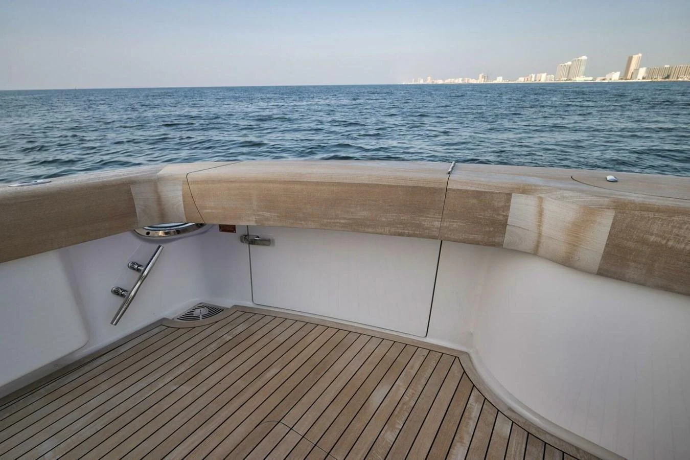The aft deck offers a serene view of the open sea with a spacious and elegant teak flooring. aboard NIKKI BELLA Yacht for Sale