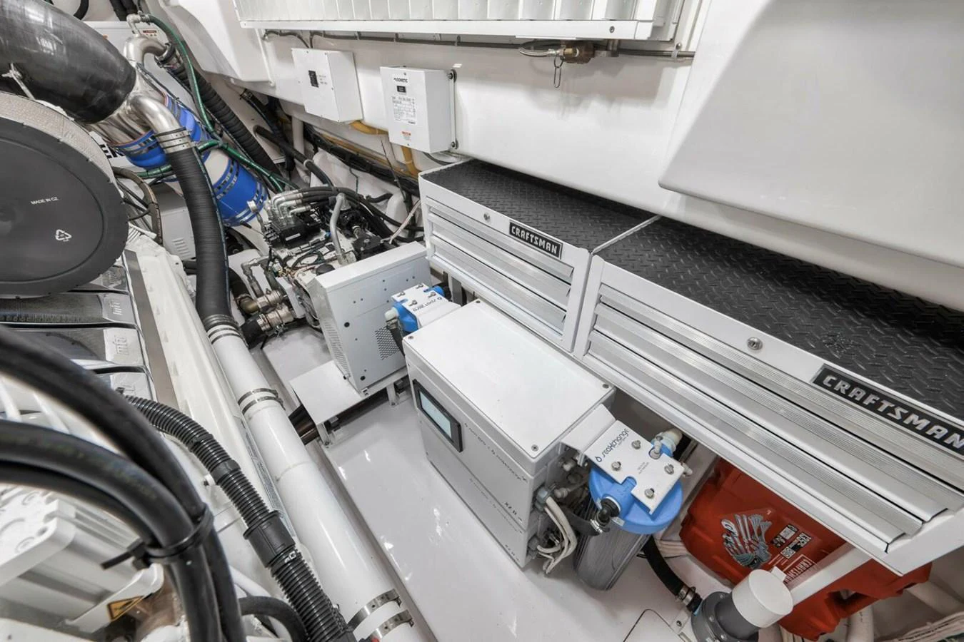 The image showcases the yacht's well-organized engine room with various mechanical components and storage units. aboard NIKKI BELLA Yacht for Sale
