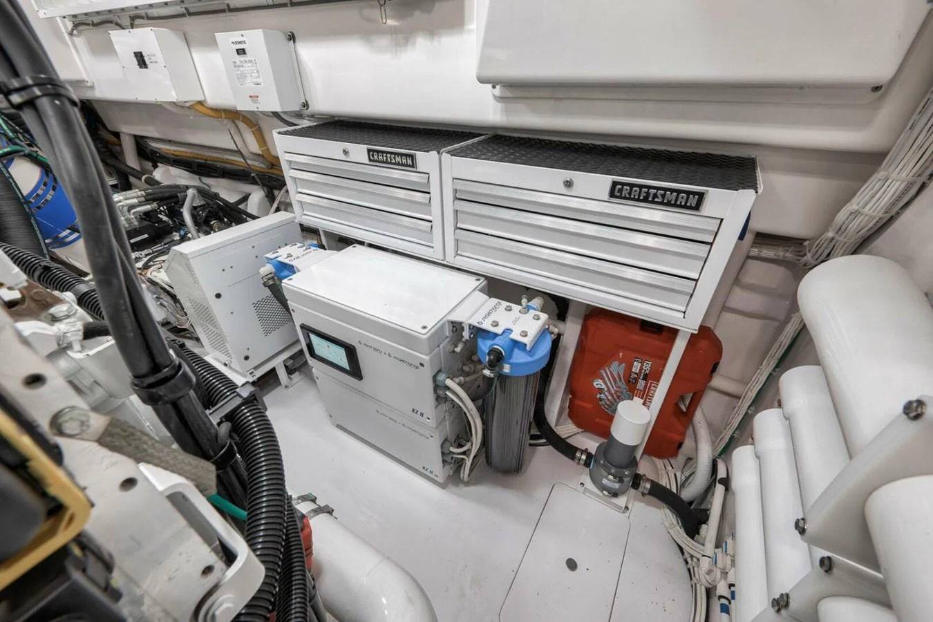 The image showcases the well-organized engine room with Craftsman tool storage and various mechanical components. aboard NIKKI BELLA Yacht for Sale