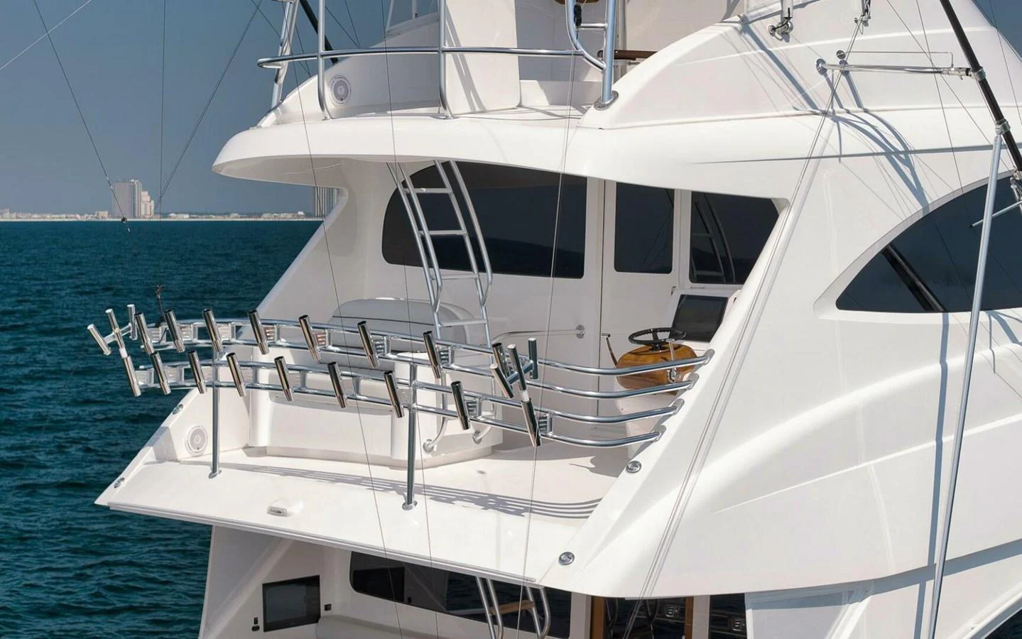 The yacht's aft deck features a well-equipped fishing setup with multiple rod holders, perfect for sport fishing enthusiasts. aboard NIKKI BELLA Yacht for Sale