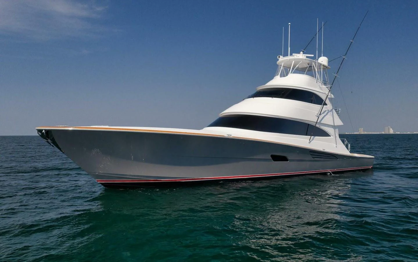 A sleek and modern yacht cruising on calm waters under a clear blue sky. aboard NIKKI BELLA Yacht for Sale