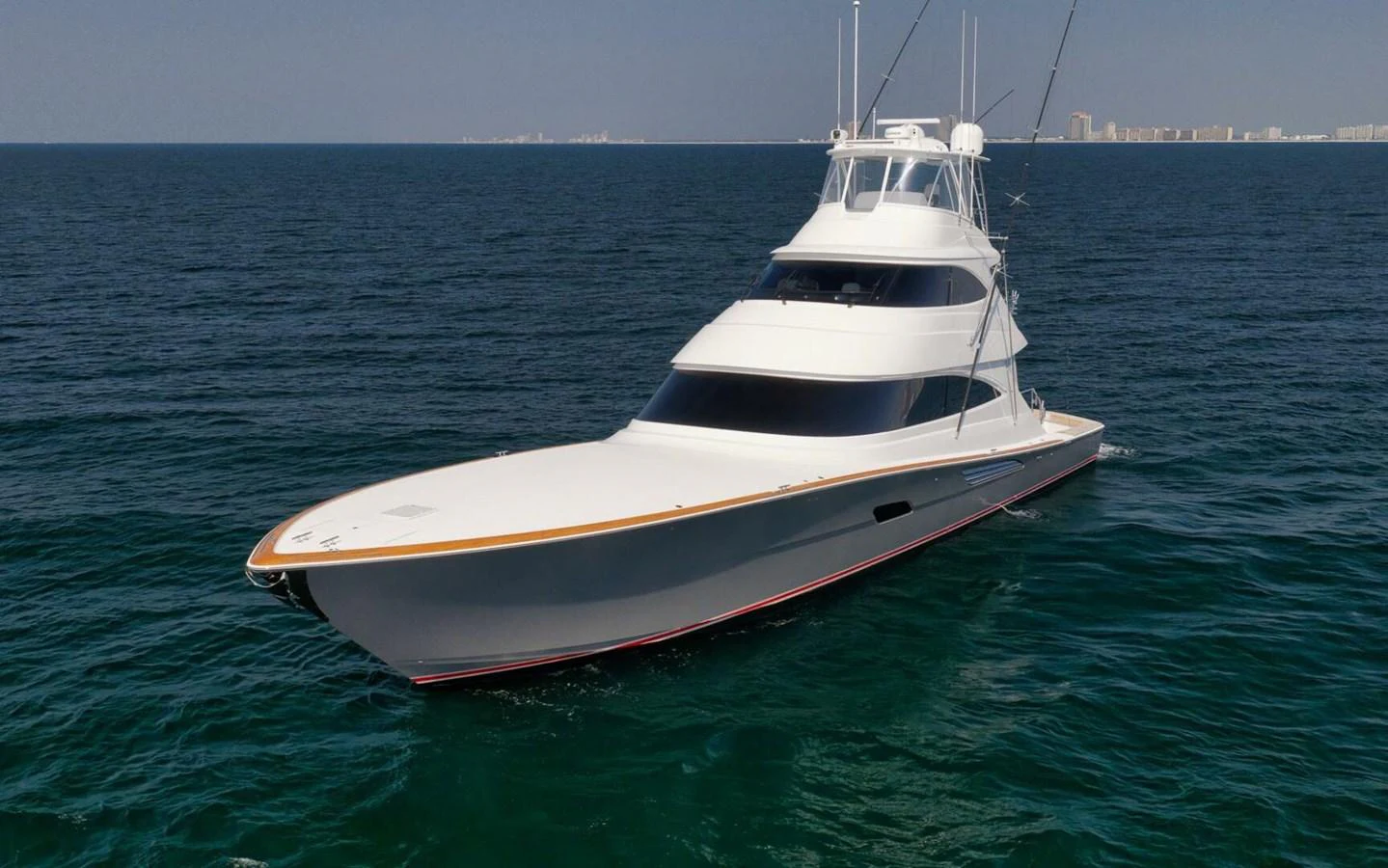 A sleek and modern yacht cruises on calm waters under a clear sky. aboard NIKKI BELLA Yacht for Sale