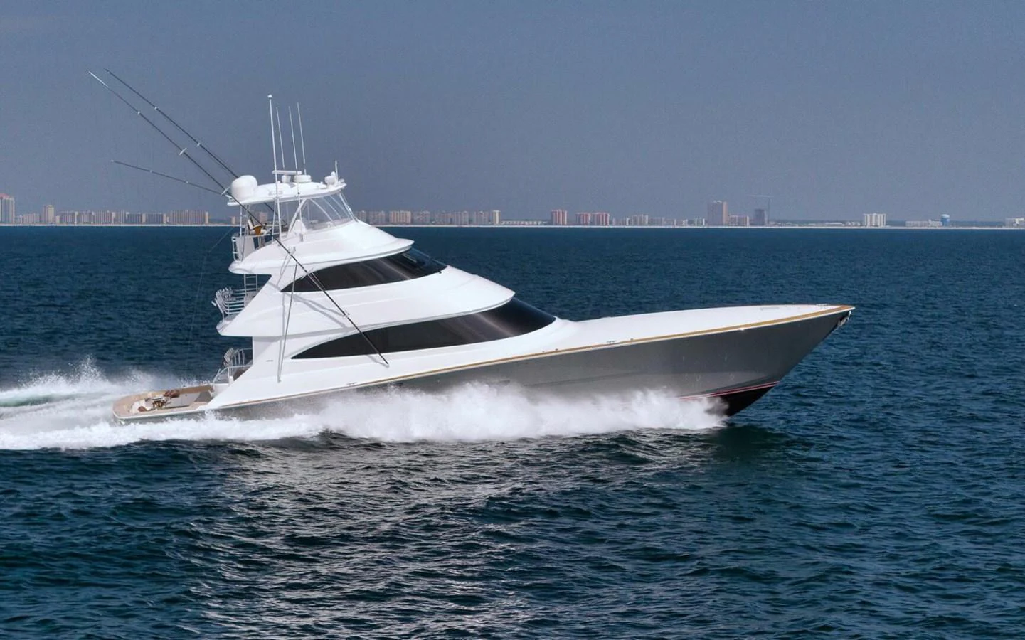 A sleek yacht cruises swiftly through the open water, showcasing its modern design and powerful performance. aboard NIKKI BELLA Yacht for Sale