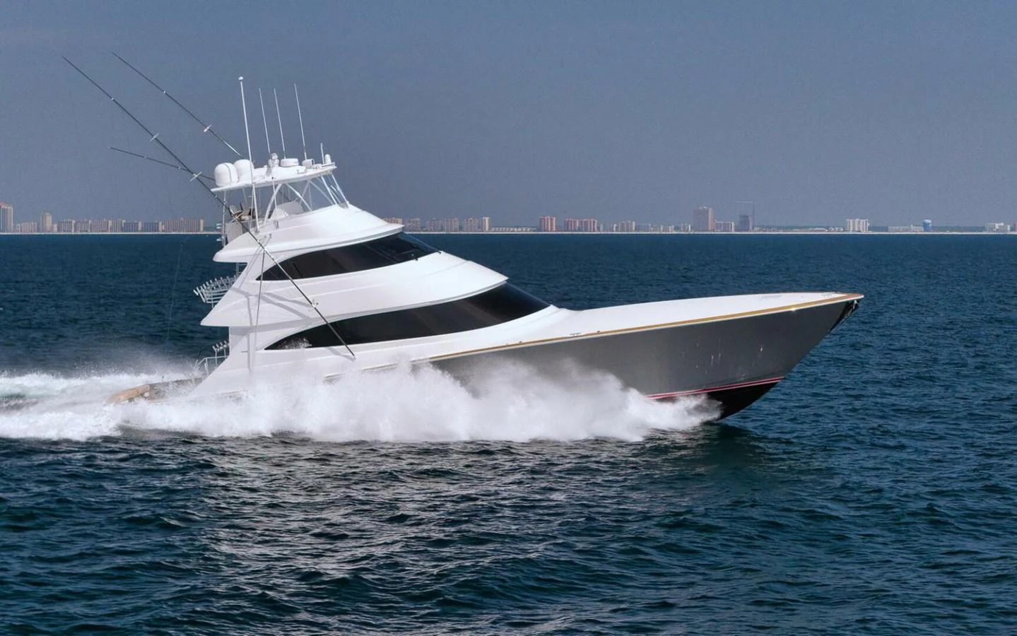 A sleek yacht cruises swiftly through the open water, showcasing its modern design and powerful performance. aboard NIKKI BELLA Yacht for Sale