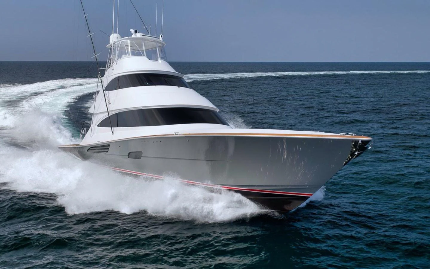 A sleek yacht cuts through the water, showcasing its powerful design and elegant lines. aboard NIKKI BELLA Yacht for Sale