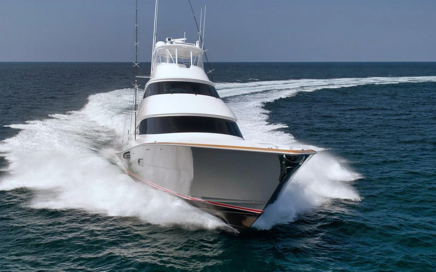A sleek yacht cuts through the water, showcasing its powerful performance and elegant design. aboard NIKKI BELLA Yacht for Sale