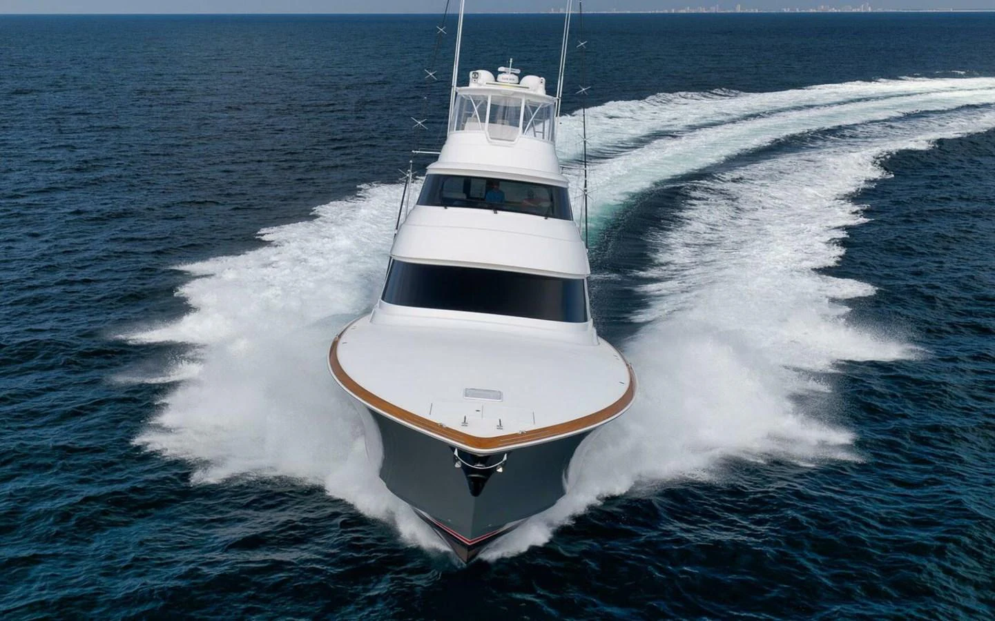 A sleek yacht cuts through the water, showcasing its impressive speed and design. aboard NIKKI BELLA Yacht for Sale