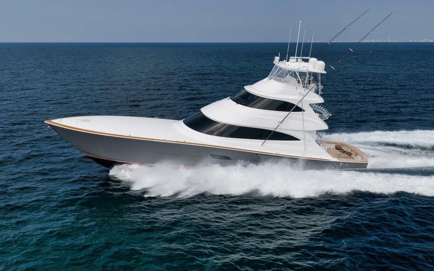 A sleek, modern yacht cruises swiftly across the open sea, showcasing its elegant design and powerful performance. aboard NIKKI BELLA Yacht for Sale