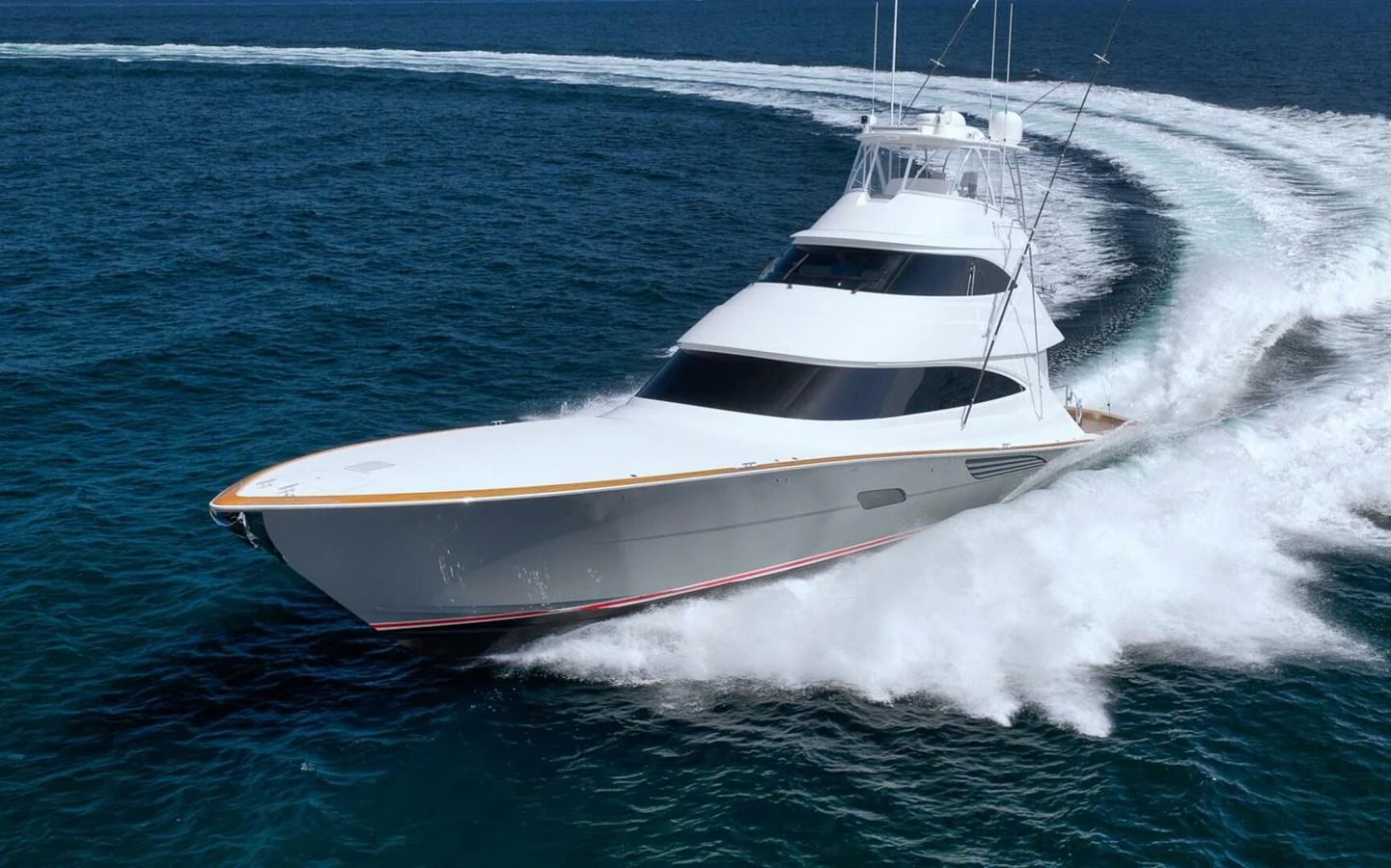 A sleek yacht cuts through the water at high speed, showcasing its powerful design and performance. aboard NIKKI BELLA Yacht for Sale