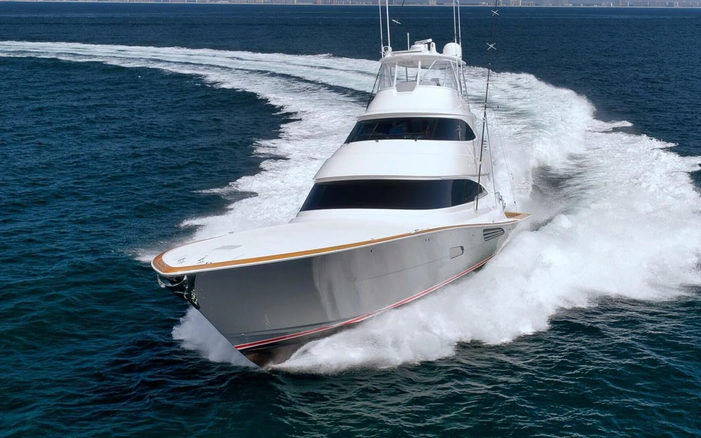 A sleek yacht cuts through the water, showcasing its powerful performance and elegant design. aboard NIKKI BELLA Yacht for Sale