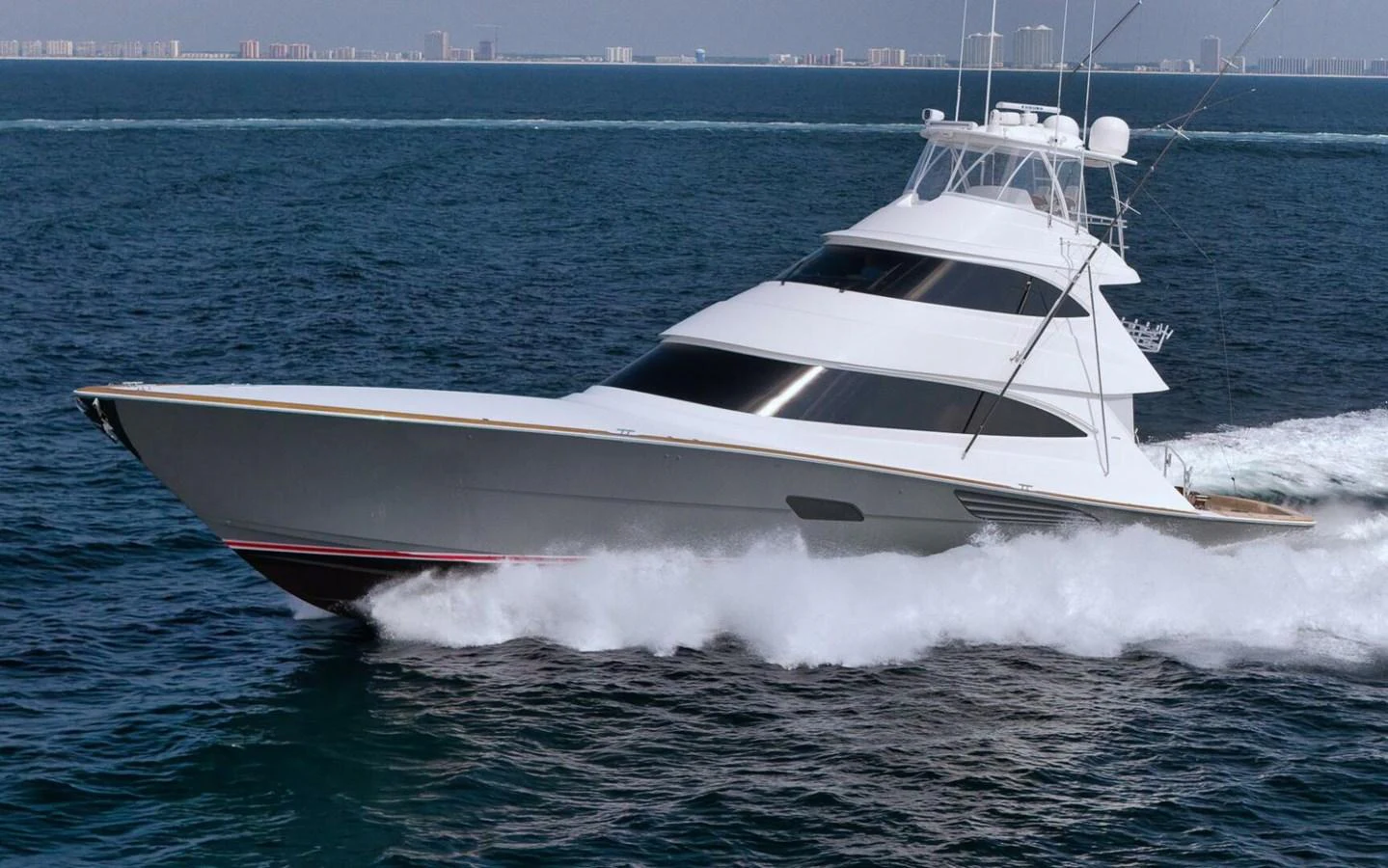 A sleek yacht cruises swiftly through the open sea, showcasing its modern design and powerful performance. aboard NIKKI BELLA Yacht for Sale