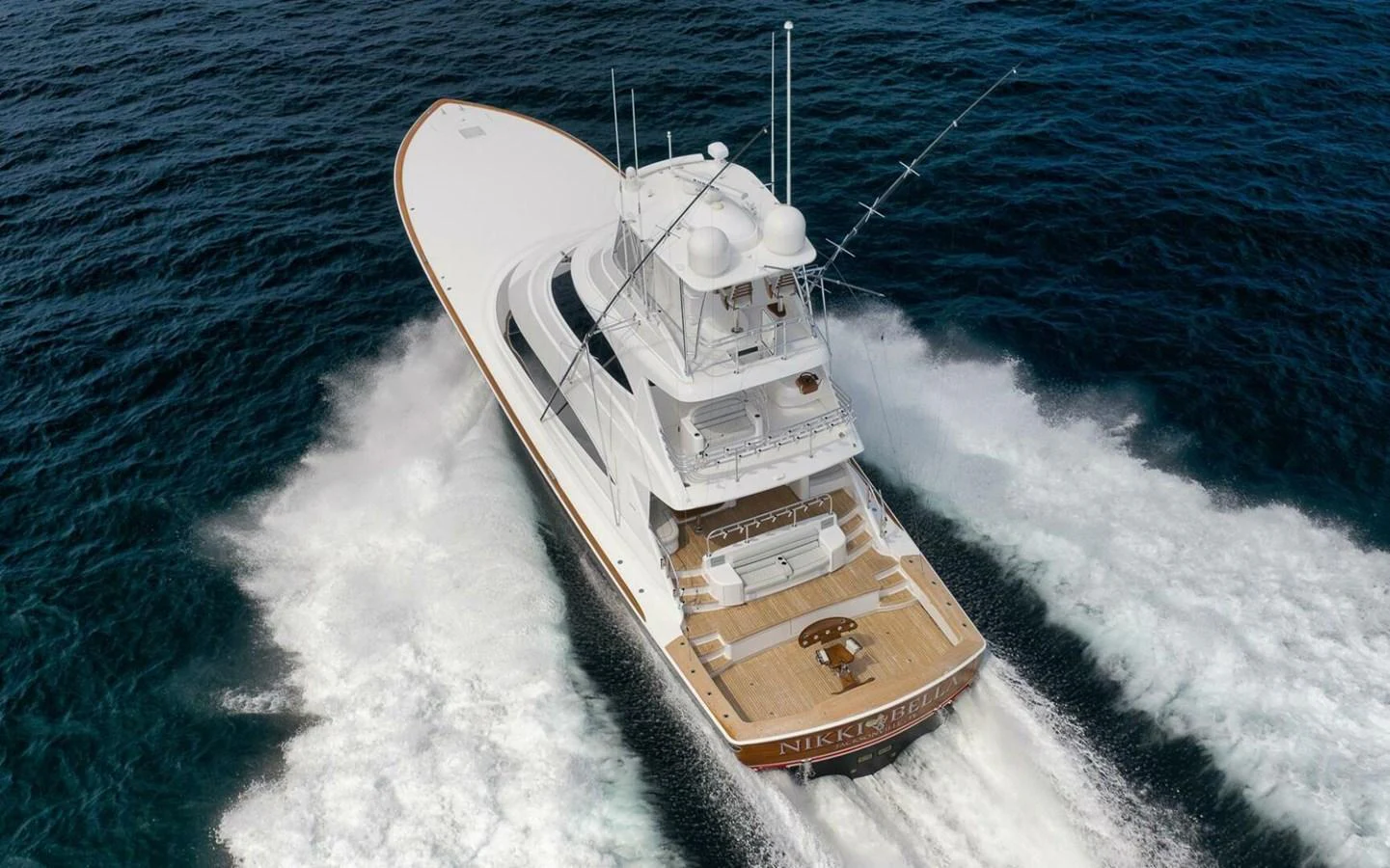 A sleek yacht cruises swiftly through the open water, showcasing its impressive design and performance. aboard NIKKI BELLA Yacht for Sale
