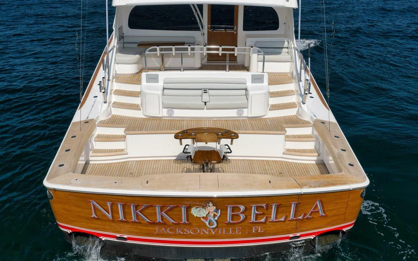 The yacht's aft deck features a spacious and inviting area for relaxation and entertainment. aboard NIKKI BELLA Yacht for Sale