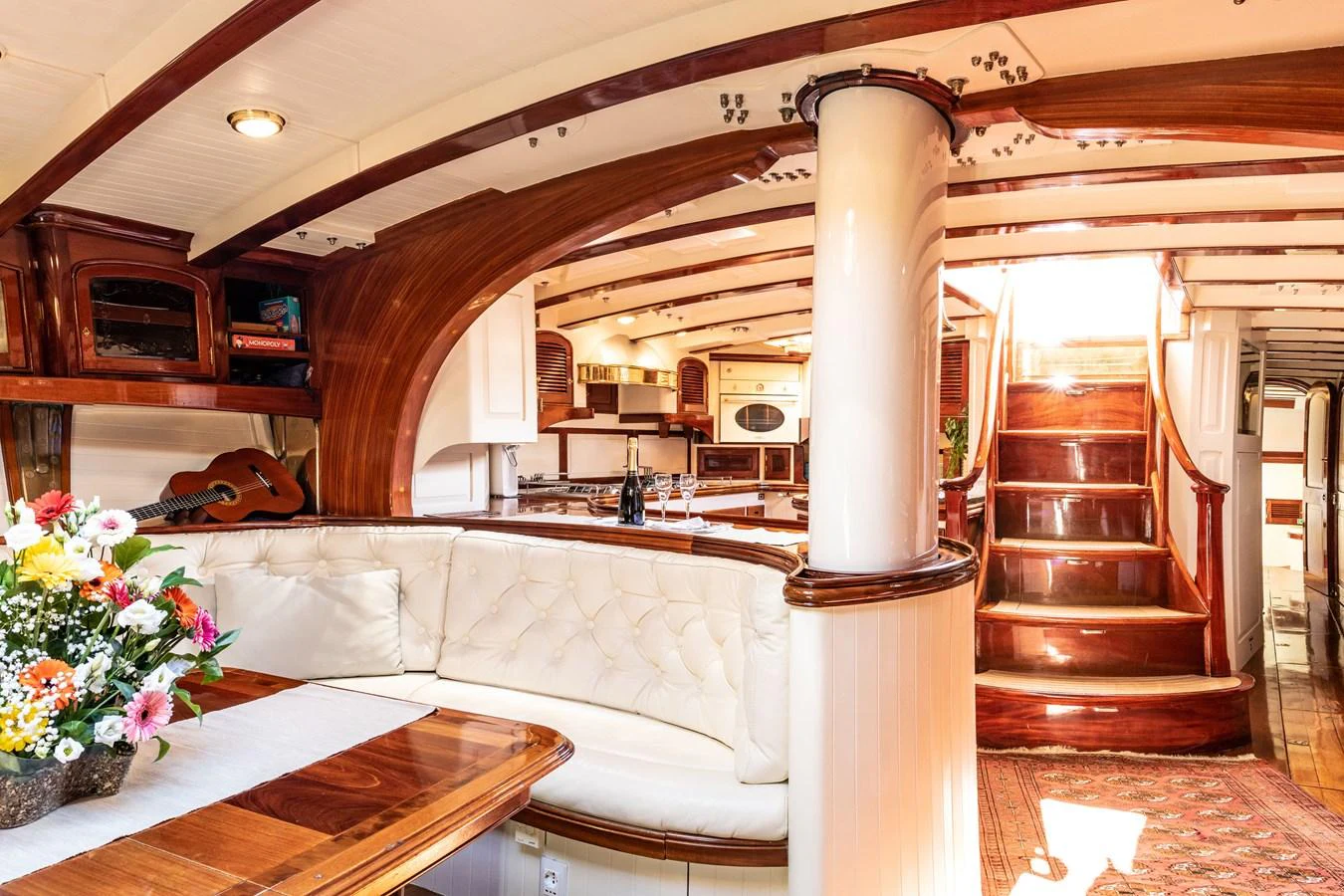 The yacht's salon features elegant wood finishes, plush seating, and abundant natural light. aboard WHITEFIN Yacht for Sale