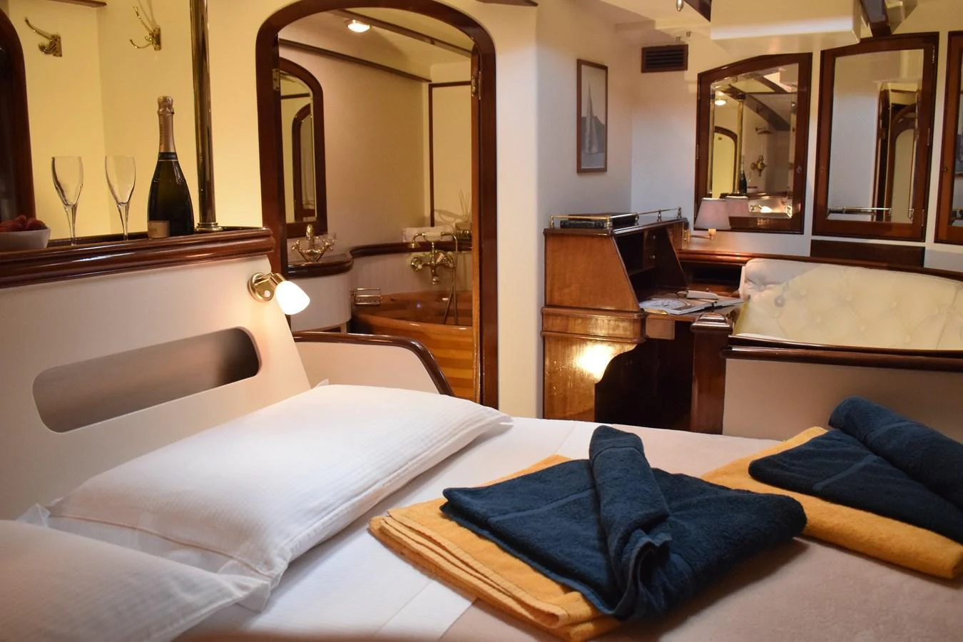 This cozy stateroom features a comfortable bed, a writing desk, and elegant decor. aboard WHITEFIN Yacht for Sale
