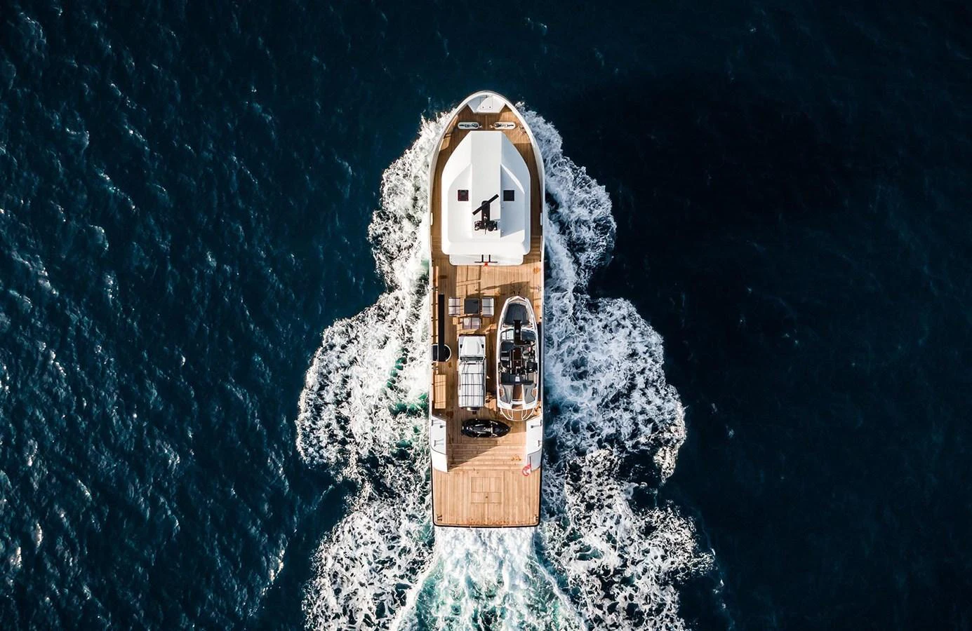 Aerial view of a yacht cruising through deep blue waters, showcasing its spacious deck and sleek design. aboard 27 YXT Yacht for Sale