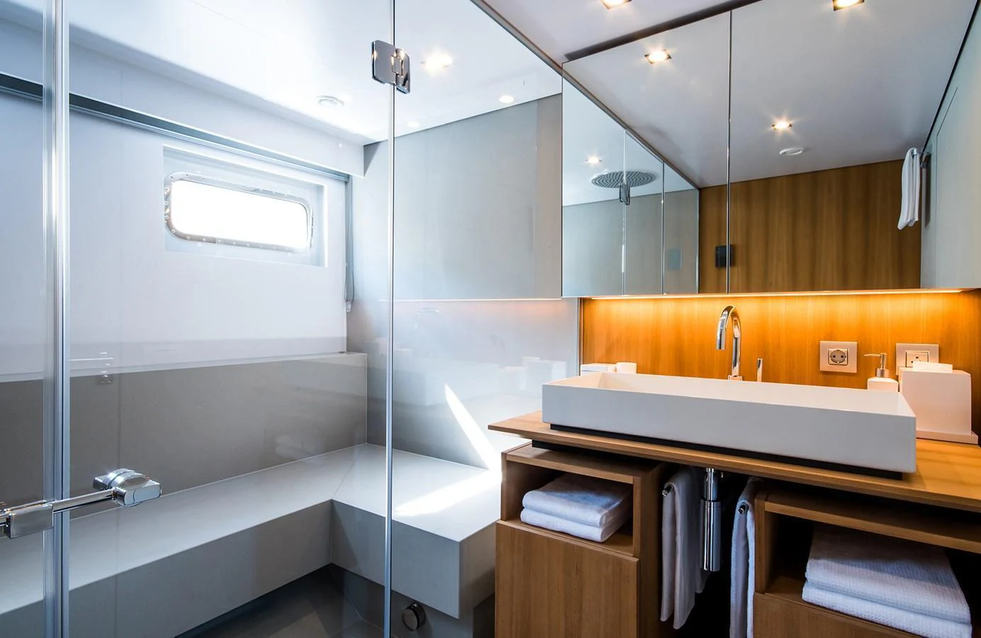 A modern yacht bathroom with sleek fixtures and ample lighting. aboard 27 YXT Yacht for Sale