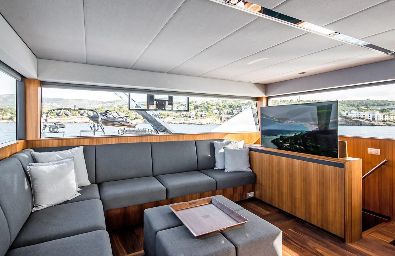 The yacht's salon features a spacious and modern seating area with panoramic windows offering stunning views. aboard 27 YXT Yacht for Sale