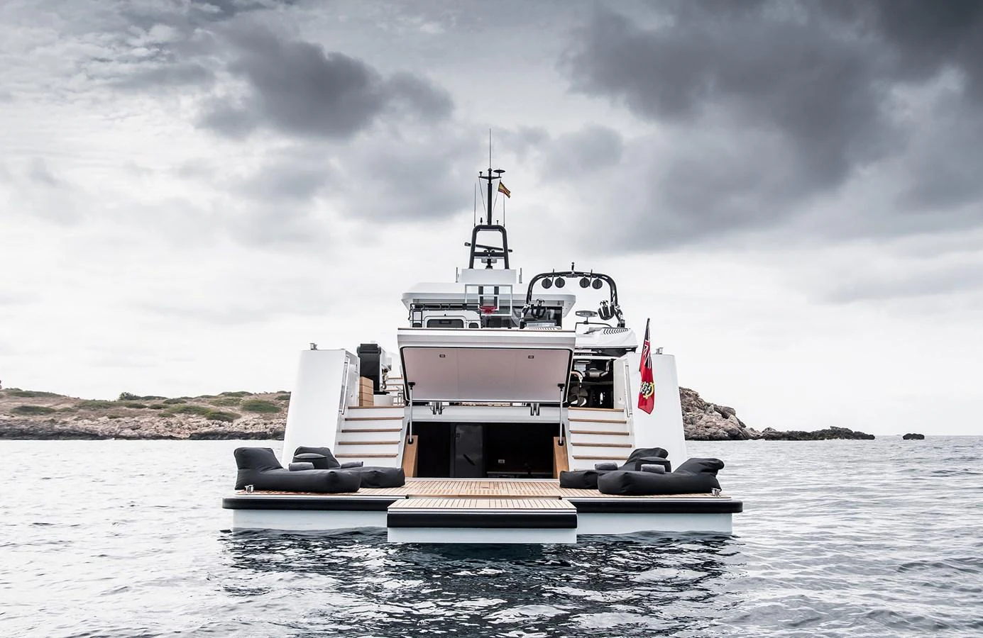 The yacht's aft deck features a spacious lounging area with a swim platform, perfect for relaxation and water activities. aboard 27 YXT Yacht for Sale