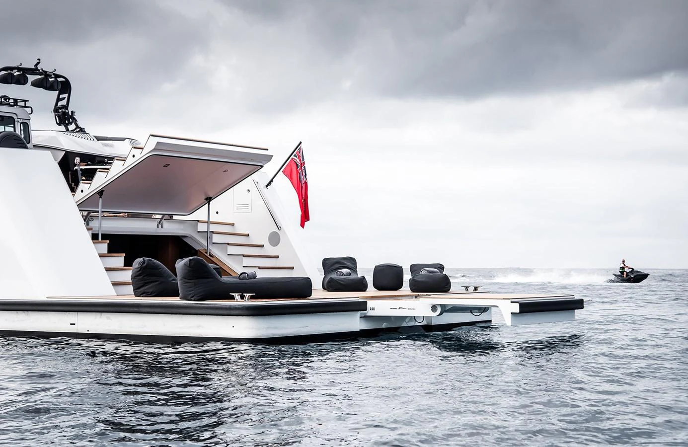 The yacht's aft deck features a spacious lounging area with bean bags, perfect for relaxation by the water. aboard 27 YXT Yacht for Sale