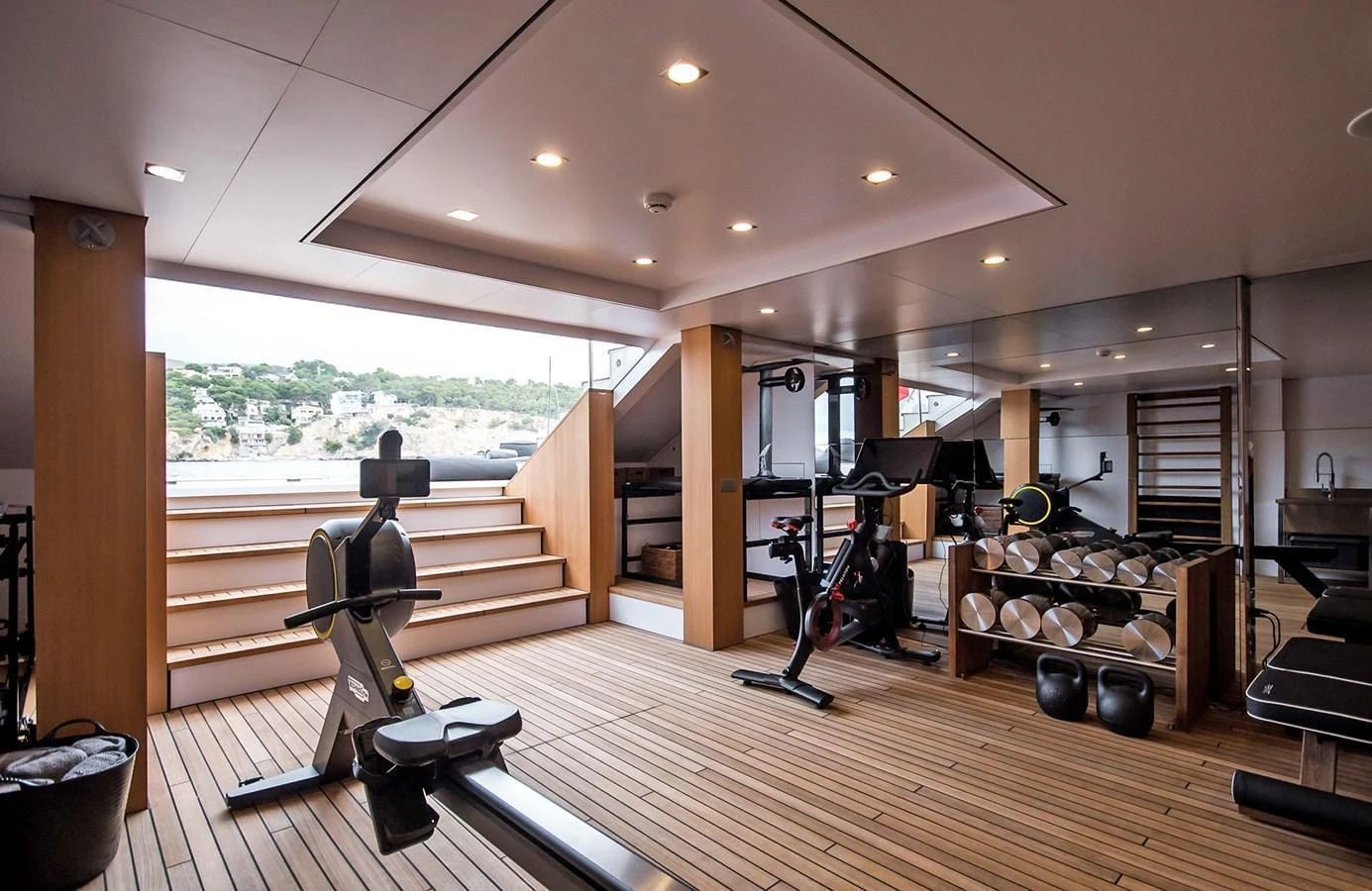 The yacht features a well-equipped gym with modern fitness equipment and a view of the surroundings. aboard 27 YXT Yacht for Sale