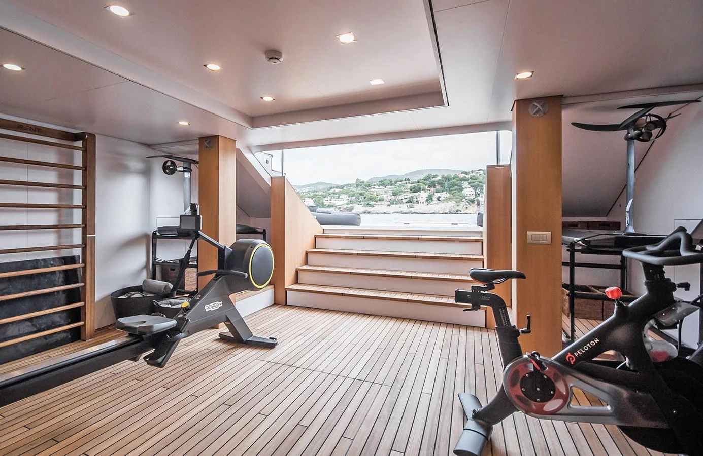 The yacht features a well-equipped gym with modern fitness equipment and a view of the surrounding landscape. aboard 27 YXT Yacht for Sale